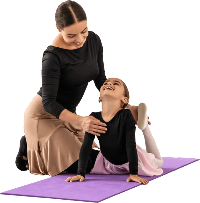 A teacher stretching with a smiling young student